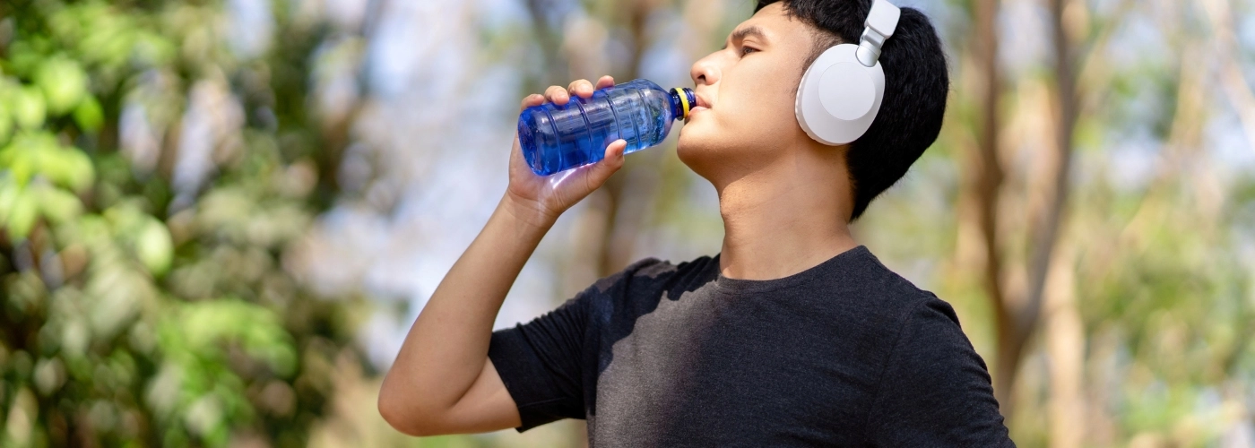 Man drinking water after physical activity to beat the heatwave in Malaysia