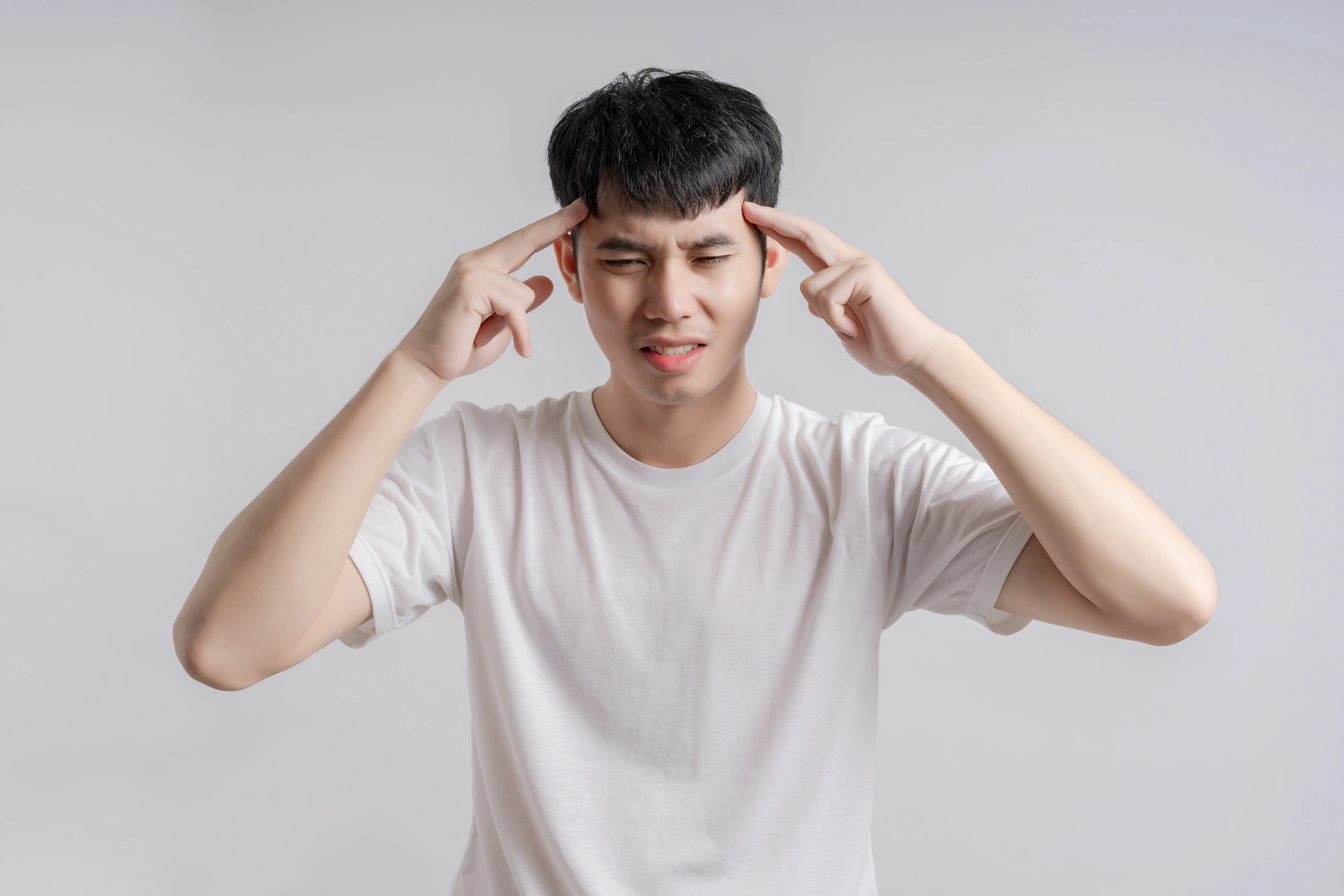 Person experiencing a symptom of a brain aneurysm