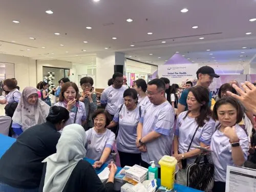 Tan (seated) visiting one of the booths during the event.